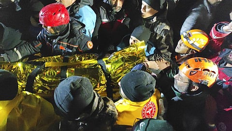 Rescue workers and medics carry a young woman they have rescued from the debris of a collapsed building in Sanliurfa, southern Turkey, late Monday, Feb. 6, 2023. (Photo | AP)