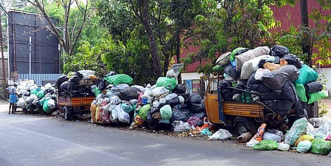 Waste wrapped in bags piled up on Thammanam- Palarivattom road. Garbage collection by Kochi corporation has been halted for more than a week. (Photo | Abel R H )