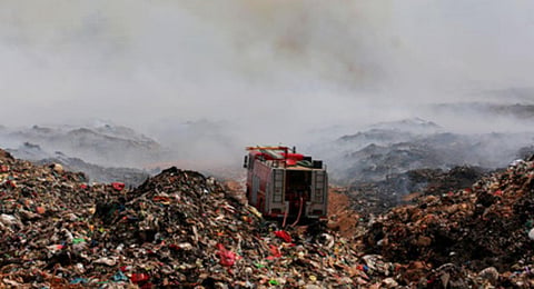 Fire and rescue personnel dousing the fire at Brahmapouram in Kochi .(Photo | Express)