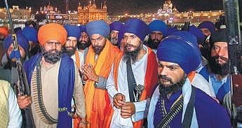 Amritpal Singh with his aide Lovepreet Singh Toofan at the Golden Temple after the latter’s release from the Amritsar Central Jail, on Friday (Photo | PTI)