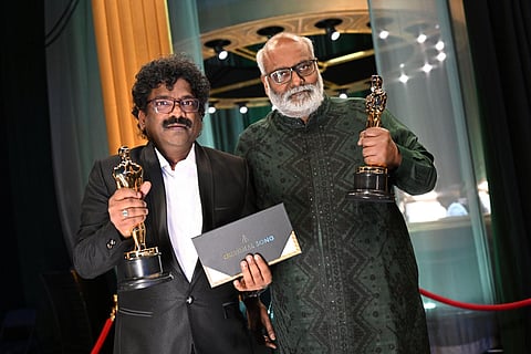 Composer MM Keeravaani and lyricist Chanrabose hold the Oscar for Best Music (Original Song) for their song 'Naatu Naatu' at the Dolby Theatre in Hollywood, March 12, 2023. (Photo | AFP)