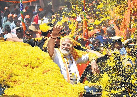 Prime Minister Narendra Modi takes part in a roadshow before the inauguration of Bengaluru-Mysuru Expressway in Mandya on Sunday | Express