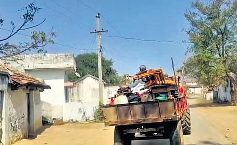 A family leaves Gudatipally with all its belongings to the make-shift tents at Nandaram village where they are building new houses.