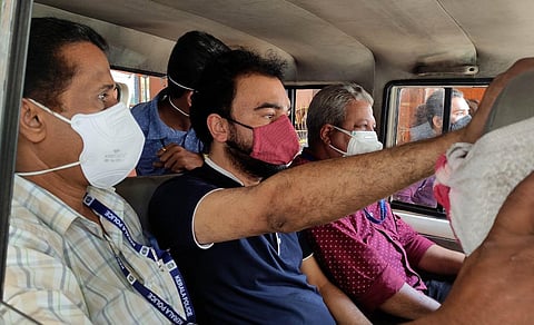 Crime Branch officials taking Monson Mavunkal (centre) after inspecting his house in Kaloor. (File Photo | A Sanesh, EPS)