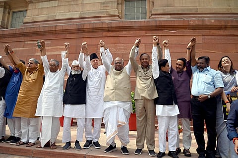 Opposition leaders on Thursday formed a human chain in the Parliament House premises demanding a probe by a joint parliamentary committee into alleged irregularities in the Adani Group. (Photo | PTI)