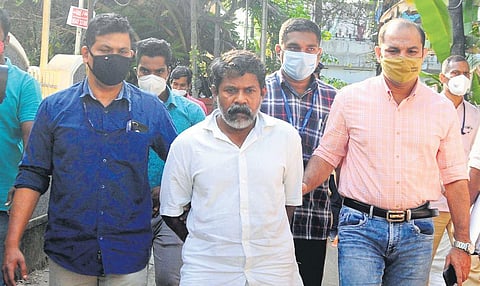 In this December 2021 image, 'Ripper' Jayanandan being taken to the house at Ponekkara in Kochi as part of evidence collection. (Photo | EPS)