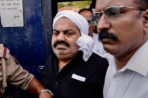 Prayagraj Police with jailed-mafia Atiq Ahmed outside Sabarmati Central Jail as he is being shifted to Prayagraj, in Ahmedabad, Sunday, March 26, 2023. (Photo | PTI)