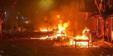 Vehicles set on fire by miscreants during clashes between two groups, at Kajipara in Howrah district. (Photo | PTI)