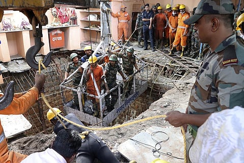 A concrete slab-roof covering an ancient stepwell caved in during the Ram Navami celebration at the Beleshwar Jhulelal Mahadev Temple in Indore's Patel Nagar area, on Thursday, 30 March 2023  at 11 am. 36 people lost their lives and several sustained injuries. (Photo | AP)