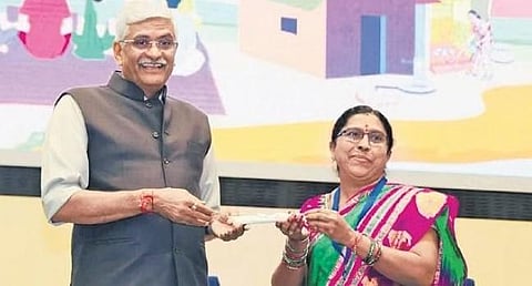 Mukhra-K sarpanch Meenakshi receives an award from Union Minister Gajender Singh Shekhawat in New Delhi on Saturday