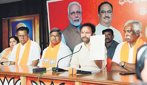 Union Minister of Tourism and Culture G Kishan Reddy shows a document as  he addresses the media at the BJP State Office in Hyderabad on Tuesday