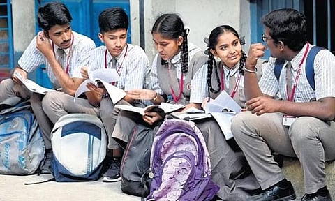 Students go through their notes and some last-minute revisions, moments before their SSLC examination, at a centre in Bengaluru on Friday | Nagaraja Gadekal