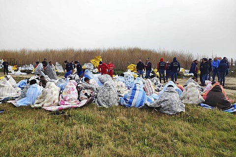 Representative Image: Rescued migrants sit covered in blankets at a beach near Cutro, southern Italy on Feb. 26, 2023 (Photo | AP)
