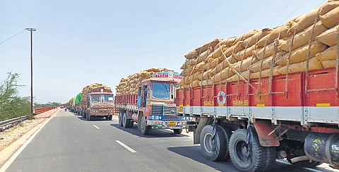 Lorries laden with fine variety of rice wait at the Chillepally toll gate on Sunday for the police to allow them to proceed. (Photo | Express)