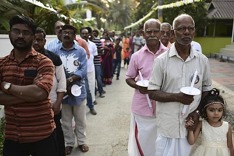 Elderly men, right and the youth participate in a church procession in Kochi, Kerala, on March 10, 2023. (Photo | AP)
