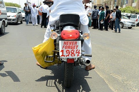 A photo of an  Indian Sikh on a motorbike with a placard as a licence plate saying 'never forget 1984', used for representative purposes only. (File Photo | AFP)