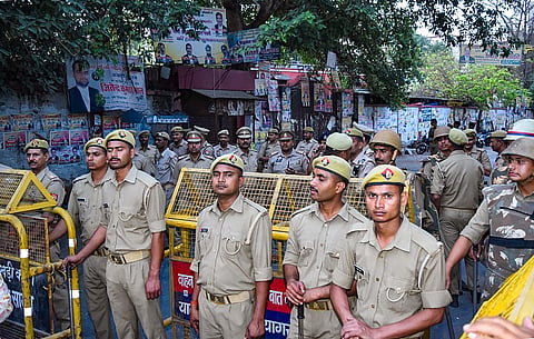 Police stand guard outside a court where three assailants who shot dead gangster-politician Atiq Ahmed and his brother Ashraf were produced in a court, in Prayagraj. (Photo | PTI)