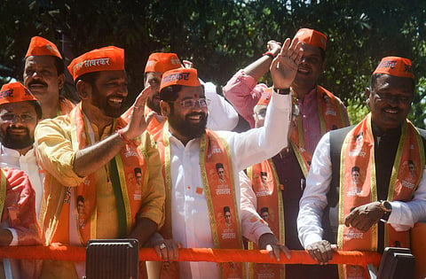 Maharashtra Chief Minister Eknath Shinde waves at supporters during the Savarkar Gaurav Yatra, organised by BJP and Shiv Sena (Shinde faction), in Thane, Sunday, April 2, 2023. (Photo | PTI)