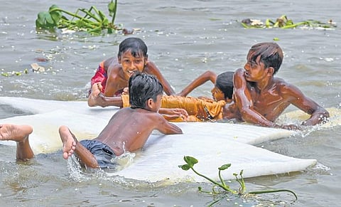 Boys swim in Hooghly river to beat the heat on a hot summer day in Kolkata  | pti