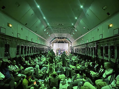 Citizens of different nationalities, fleeing from Sudan, sit inside a Spanish Air Force aircraft on its way to Madrid on Monday, April 24, 2023. (Photo | AP)