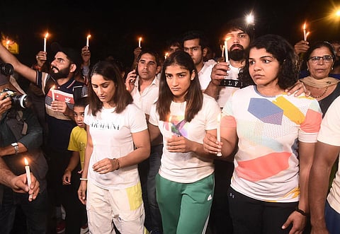 Wrestlers Vinesh Phogat, Sangeeta Phogat and Sakshi Malik during a candle march in New Delhi. (Photo | Parveen Negi, EPS)