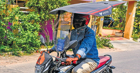 Ola driver Unni Krishna Kumar with his bike in Vijayawada | Prasant Madugula