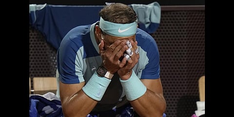FILE: Rafael Nadal touches his face during his match against Denis Shapovalov of Canada at the Italian Open tennis tournament, in Rome, May 12, 2022.(Photo | AP)
