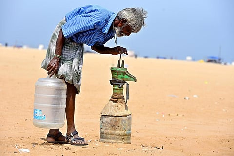 A local shop vendor checks a broken water pump for groundwater in Marina Beach, Chennai. Image used for representational purpose. (Photo | P Ravikumar, EPS)
