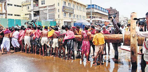 Biswakarma servitors fixing wheels to a chariot axle in Puri on Friday | Express