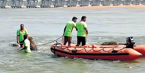 Fire and rescue services personnel searching for the two boys who were washed away in the Kollidam on Sunday | Express