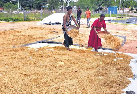 Farmers dry soaked paddy in  Jangaon district on Monday