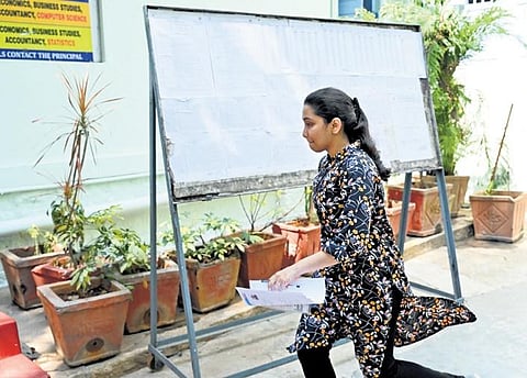 A student runs towards the entrance of an examination centre of the Common Entrance Test in Bengaluru on Sunday. (Photo | Nagaraja Gadekal)