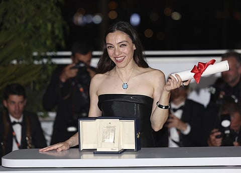 Merve Dizdar, winner of best actress for 'About Dry Grasses,' poses during a photo call following the awards ceremony at the 76th international film festival, Cannes. (AP)