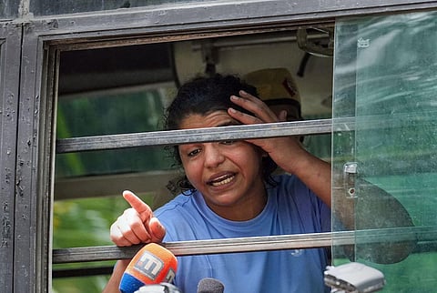 Wrestler Sakshi Malik after being detained by police during wrestlers' protest march towards new Parliament building, in New Delhi, Sunday, May 28, 2023. (Photo | PTI)