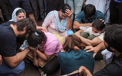 Protesting wrestlers Sakshi Malik, Vinesh Phogat and Sangeeta Phogat sit at Har ki Pauri ghat, in Haridwar, Tuesday, May 30, 2023. (Photo | PTI)