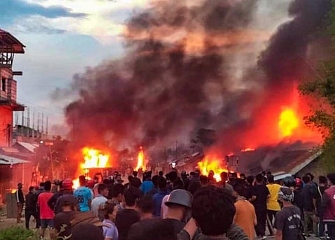 People at the site of a fire incident after violence broke out in Manipur on Wednesday between tribals and non-tribals during 'Tribal Solidarity March'. (Photo | PTI)