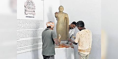 Workers move a statue of Buddha at YSR Archaeological Museum on Friday