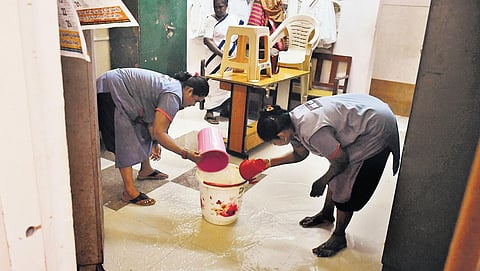 Vijayawada GGH workers draining out stagnated water after heavy rainfall lashed the city on Friday | Prasant Madugula