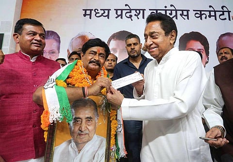 Madhya Pradesh Congress President Kamal Nath presents party membership slip to former MLA Deepak Joshi at party office in Bhopal, Saturday, May 6, 2023. (Photo | PTI)