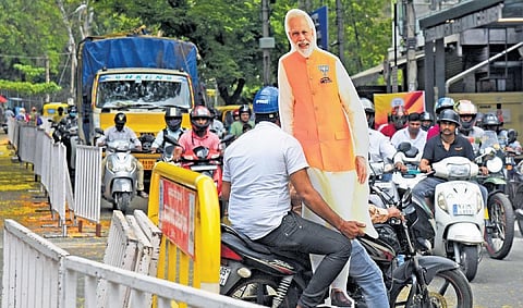 People wait to have a glimpse of Prime Minister Narendra Modi in Bengaluru on Saturday | Shashidhar Byrappa