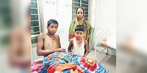 Suraj Kumar with his mother and brother at SCB Medical College and Hospital I Express
