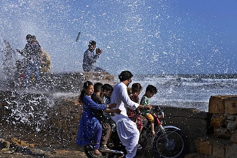 People enjoy high tide waves on the Arabian Sea in Karachi, Pakistan, Sunday, June 11, 2023. (Photo | AP)