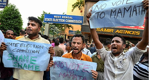 BJP workers stage a protest against TMC party over obstruction by TMC in filing of nomination papers for panchayat polls by the BJP candidates, in front of SEC office. (Photo | PTI)