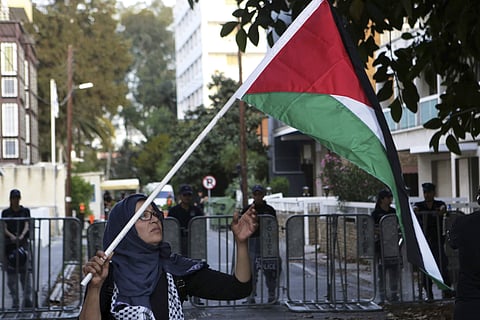 Representational image: A Palestinian woman holds up the Palestine flag outside Israeli embassy. ( Photo | AP )