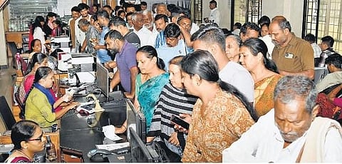 People throng the BengaluruOne centre to register for the Gruha Jyothi scheme,  in JP Nagar, Bengaluru.