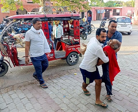 Family members bring a patient at a hospital during heatwave conditions, in Ballia, Uttar Pradesh, on June 18, 2023. (PTI)