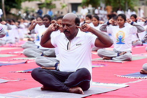 Health minister Ma Subramanian along with students and patients of Yoga and Natural Medicine doing Yoga at their college ground at Annanagar during International World Yoga Day. (Photo | Express)