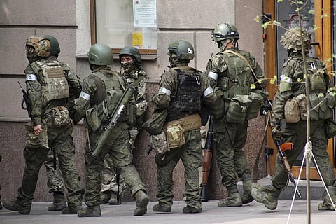 Russian servicemen guard an area in a street in Rostov-on-Don, Russia. (Photo | AP)