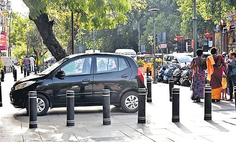 Vehicles parked on the pedestrian plaza at Pondy Bazaar in T Nagar makes it difficult for people to walk through | P Jawahar
