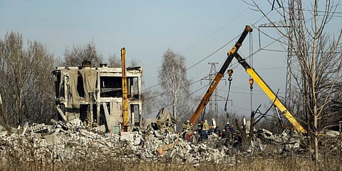 Workers clean rubbles after Ukrainian rocket strike in Makiivka, in Russian-controlled Donetsk region, eastern Ukraine. (File Photo | AP)